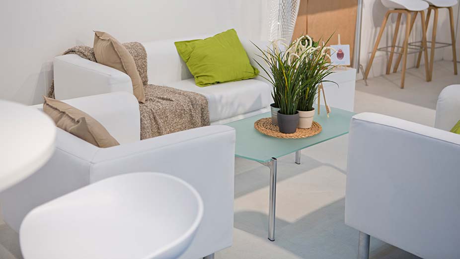 Rental furniture & equipment: White sofa with two white armchairs, a glass coffee table and white stools